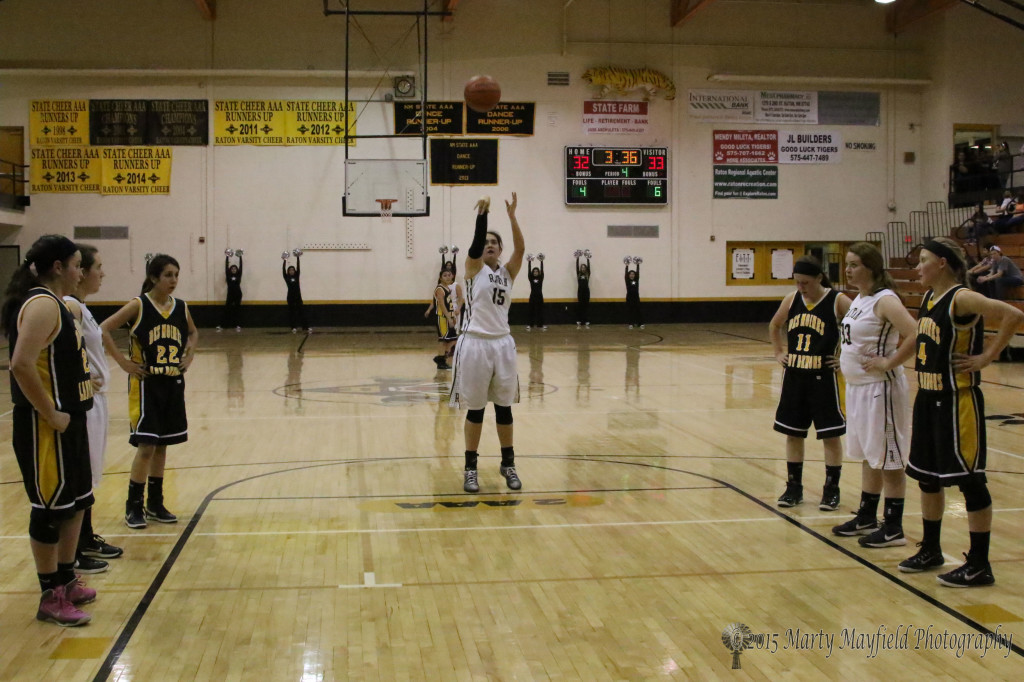 The scoreboard indicates its a close game as Tarryn Trujillo puts up a free throw