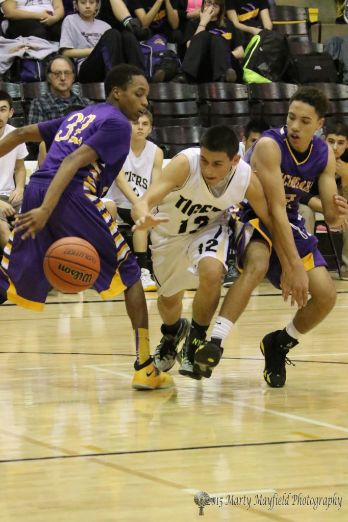 Jodus Gonzales looses the ball as he squeezes through the double team that the Tigers so often found themselves battling Saturday night in Tiger Gym against the Rattlers