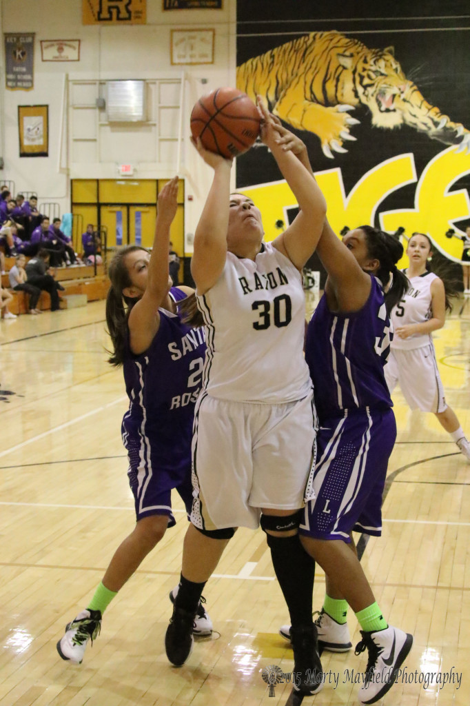 Sydni Silva goes up for the shot as Sydney Moncayo gets a hand on her for the foul during the girl's varsity game Friday night in Tiger Gym