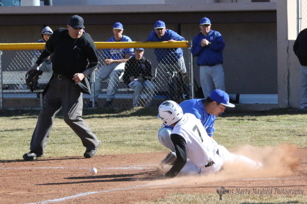 The St Mikes pitcher just misses the throw from the catcher and Brandon Luksich makes the slide in safe.