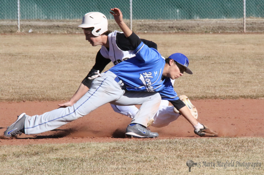 Whoops! the St Mikes shortstop misses the ball as Dakota Montana falls for 2nd base.
