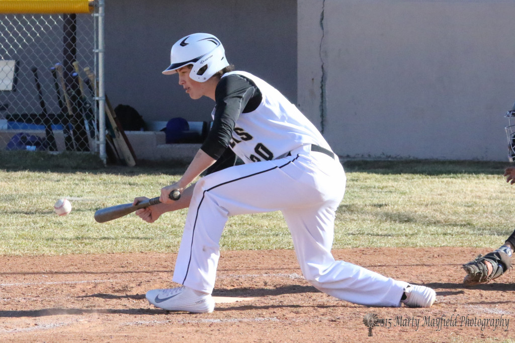 Dakota Martinez goes for the bunt during the game with St Mikes Tuesday afternoon.