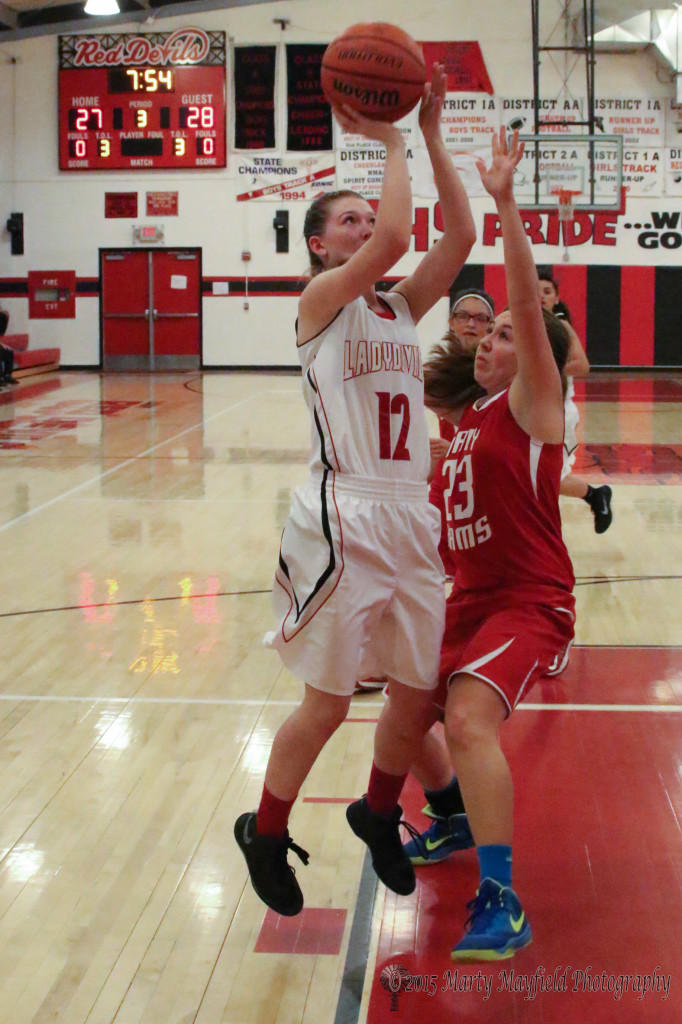 Kara Burton (12) takes the shot for two of her 22 points Monday evening during the District 5A Championship game.