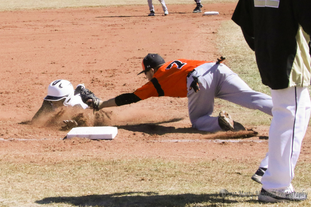 its a close one as Adam Abeyta reaches for Trevor Portillos as he slides to third base early in game 1. 