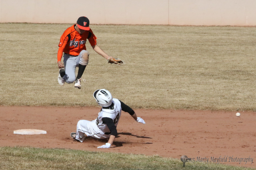 Martin Ortiz slides into second as the ball heads into centerfield during game 2 of the double header Saturday.