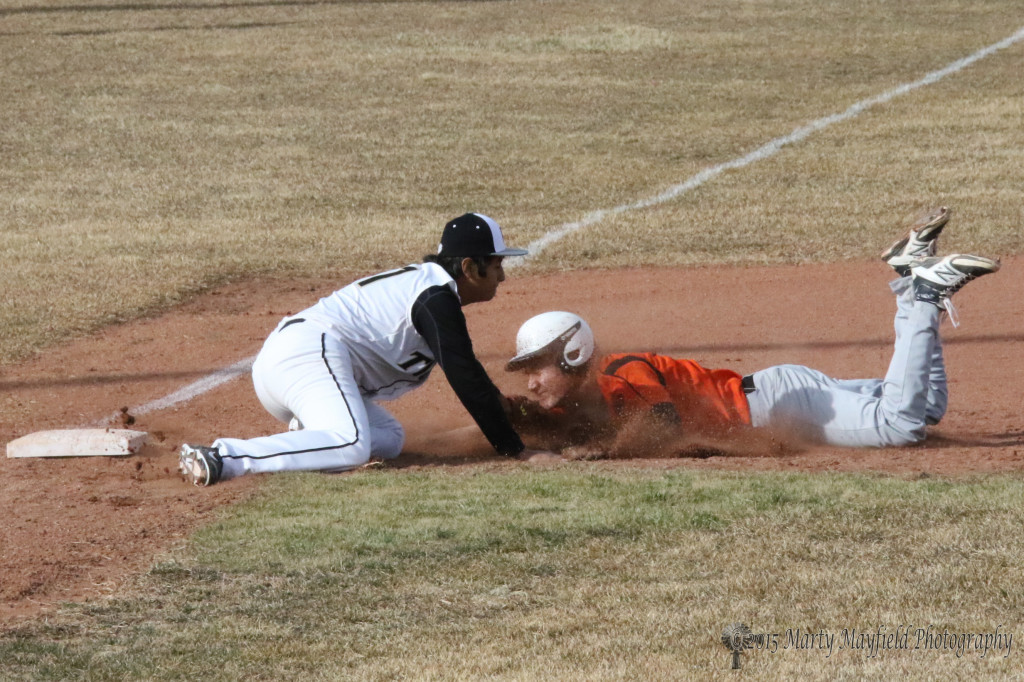 Ritchie Gonzales makes the tag well before third base for the out during game 2 of the double header with Taos Saturday at Gabrielle Field.