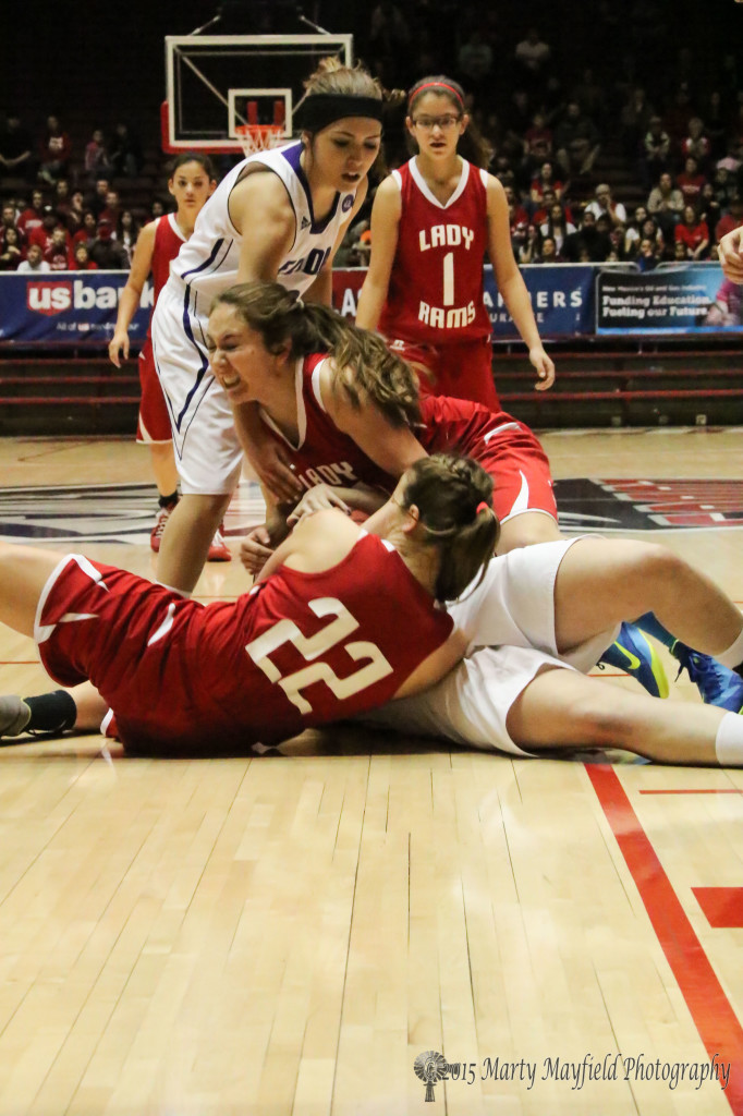 Amy Gonzales and Gentry Haukabo wrestle for the ball during the state championship game with Elida