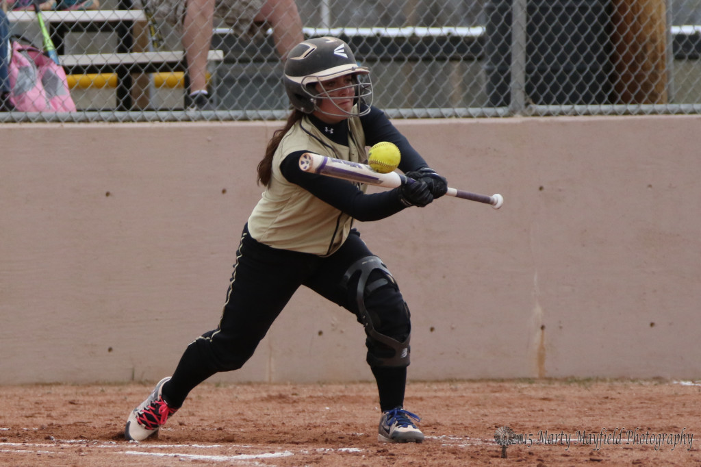 Caydence Sisneros makes contact with the ball for a bunt to move players around the bases 