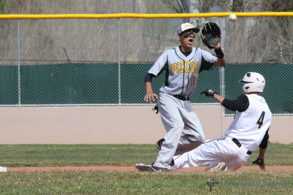 Ethan Washburn (4) just slides past the 2nd baseman Mario Archuleta during the Raton Pecos double header Monday afternoon