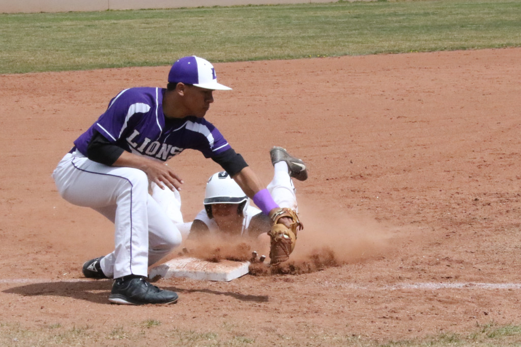 Dillon Lemons beats the ball to third base as Raton base runners continue to round the bases Saturday