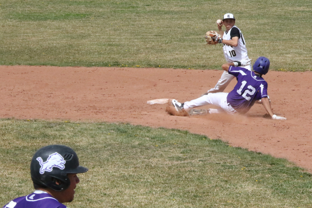 Jacob Sanchez (12) takes the slide but its to late as Damien Martinez (10) prepares to throw to first after tagging second for the force out. The throw to first however was a bit late.