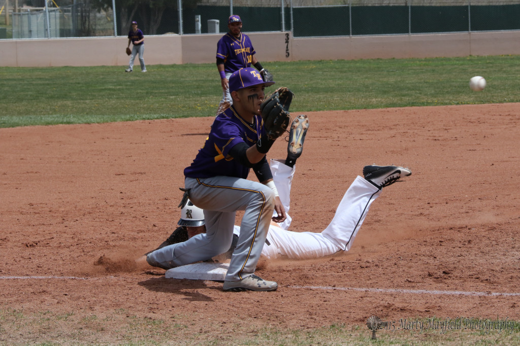 Ethan Washburn takes to the dirt at third well ahead of the ball early in the game with Tucumcari Saturday