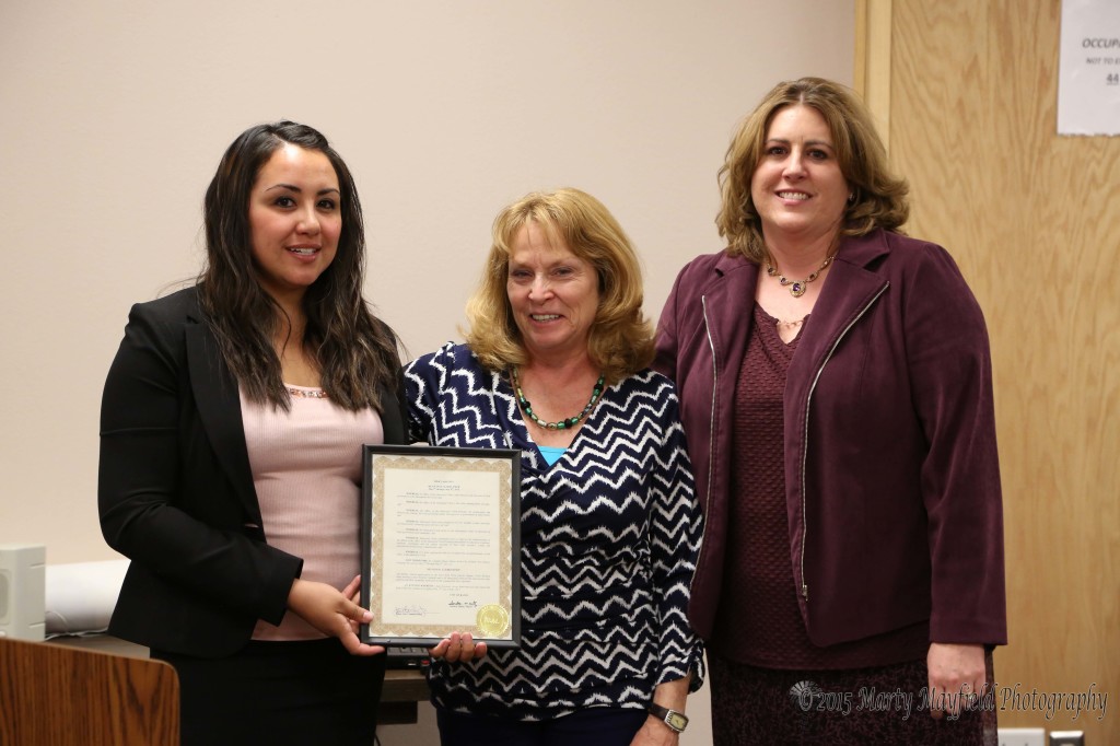 Tricia Garcia and Michael Ann Antonucci accept the proclamation for Clerk's Week from Commissioner Linde Schuster. Michael Ann and Christine Valentini have also been designated as deputy clerks