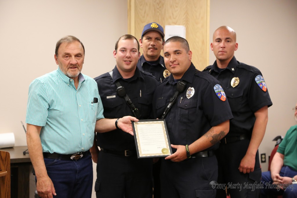 Firefighter Nick Riso, Lt Ken Gonzales, Firefighter Carl Ortiz and Captain Anthony Burk accept the proclamation from Commissioner Don Giacomo for EMS week.