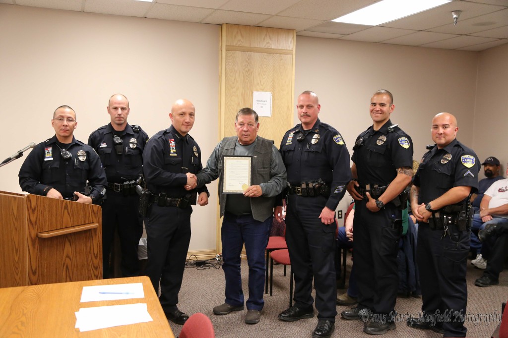 Commissioner Ron Chavez presents the proclamation for police week to Chief John Garcia along with Orlando Avila, Scott Vinson, Captain John Valdez, Keanu Trujillo and Robert Gonzales. 