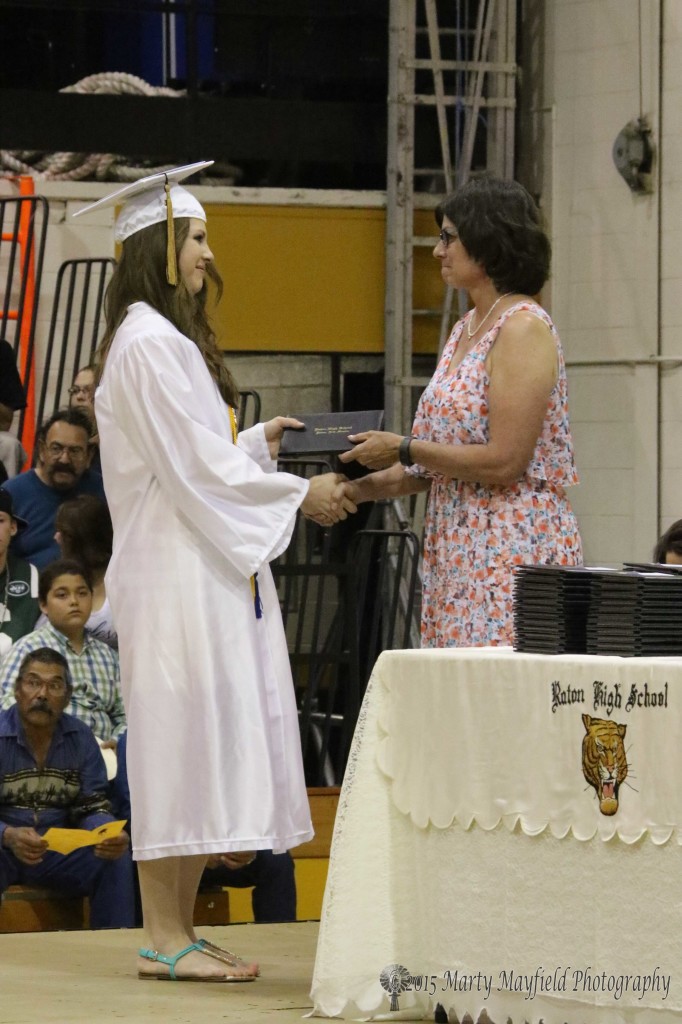 Valedictorian Kristina Jansen was handed her diploma by her mother Stephanie Jansen a former school board member.
