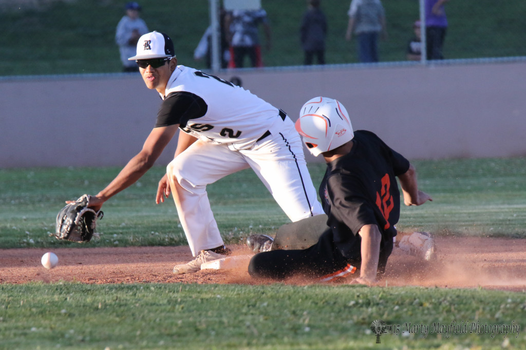 Koy Geary slides into second as the ball arrives to Jonathan Cabrieles 