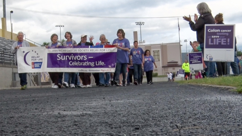 Supporters clap and cheer as the survivor's lap gets underway at the 2015 Relay for Life event held Friday and Saturday at Tiger Stadium.