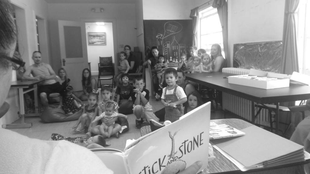 Nena Lopez reading to age group birth to kindergarten.  Some are so tiny they need to be held.  Photo by Colette Armijo.