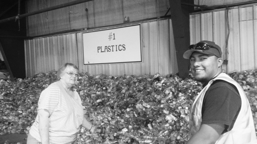L-R, Florence Higgins, a Raton recycling regular and Larry Marquez, Raton Recycling Facility Operator, making light of a Saturday morning recycling chore.  Photo by Colette M. Armijo.