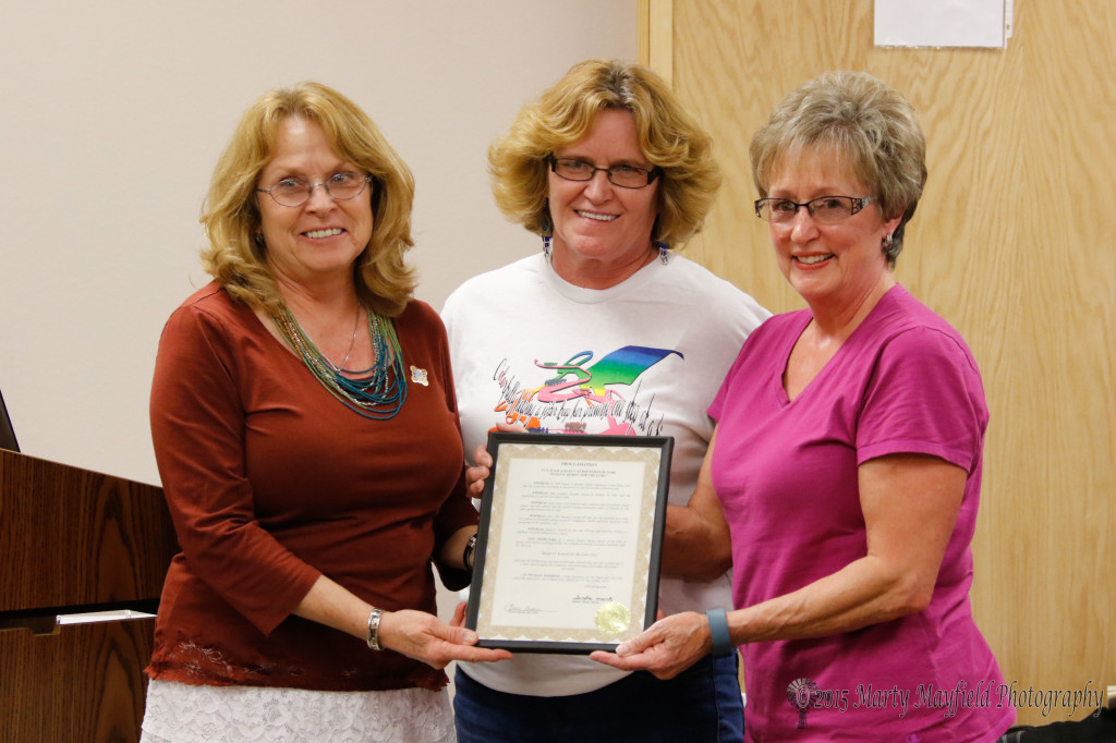 Commissinoer Linde Schuster presented the proclamation to Jami Esquibel and Karen Wiseman for the Susan G Koman Walk for the Cure 
