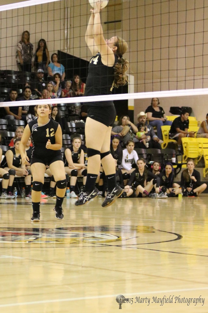 Heather Sandoval goes up to push the ball back over the net in the JV game with Des Moines Saturday afternoon.