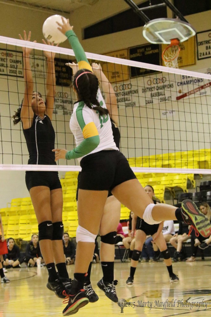 Autumn Archuleta and Heather Sandoval go for the block as Kiana Vigil goes for the spike during the JV game Friday evening