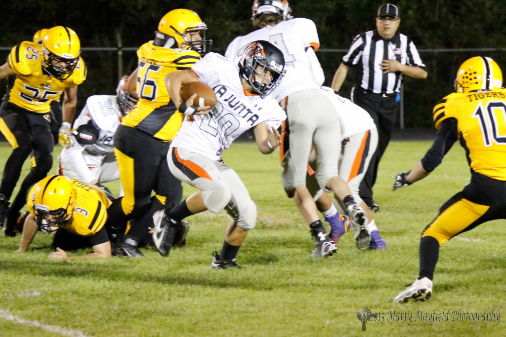 Steven Fabela breaks through the line and heads south before being brought down by a host of Raton Tigers.