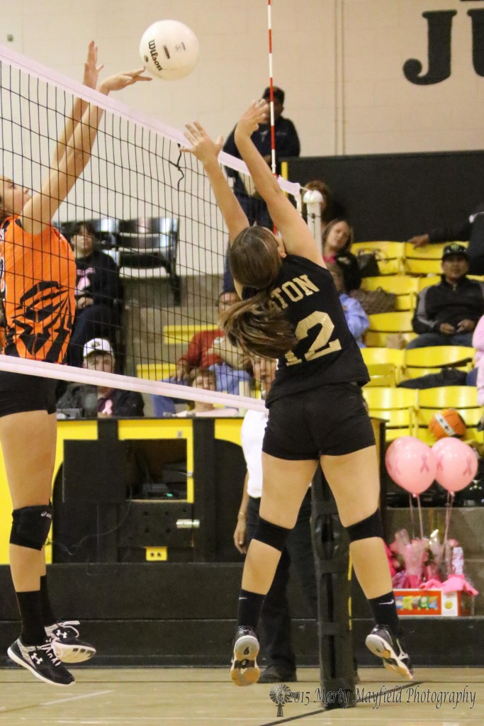Yellowjackette Mikayla Baker tips the ball that Andie Ortega pushed over the net during the JV game with Clayton Saturday afternoon.