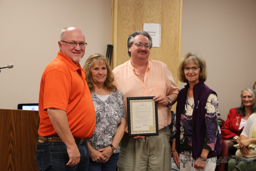 Janise Stuart, Lee Phillips and Mercy Swanson accept the Proclamation for Domestic Violence Awareness Month from Mayor Pro-Tem Neal Segotta