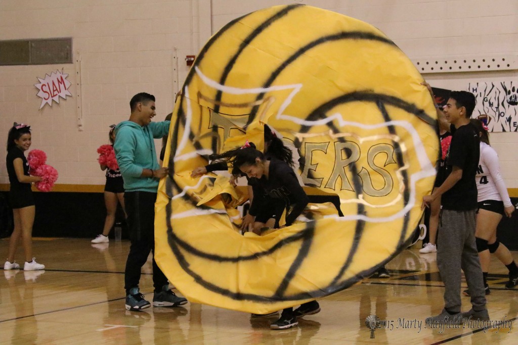 The girls break through the ball as they enter the court for play Friday evening.