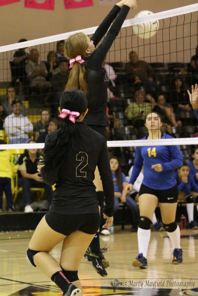 Alina Pillmore makes the block for the point late in the match with Penasco Friday evening.