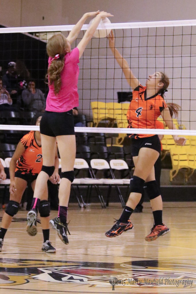 Yellowjackette Sierra Skaggs meets up with Alina Pillmore as she gets the block at the net for Raton during the district match with Clayton Saturday afternoon.
