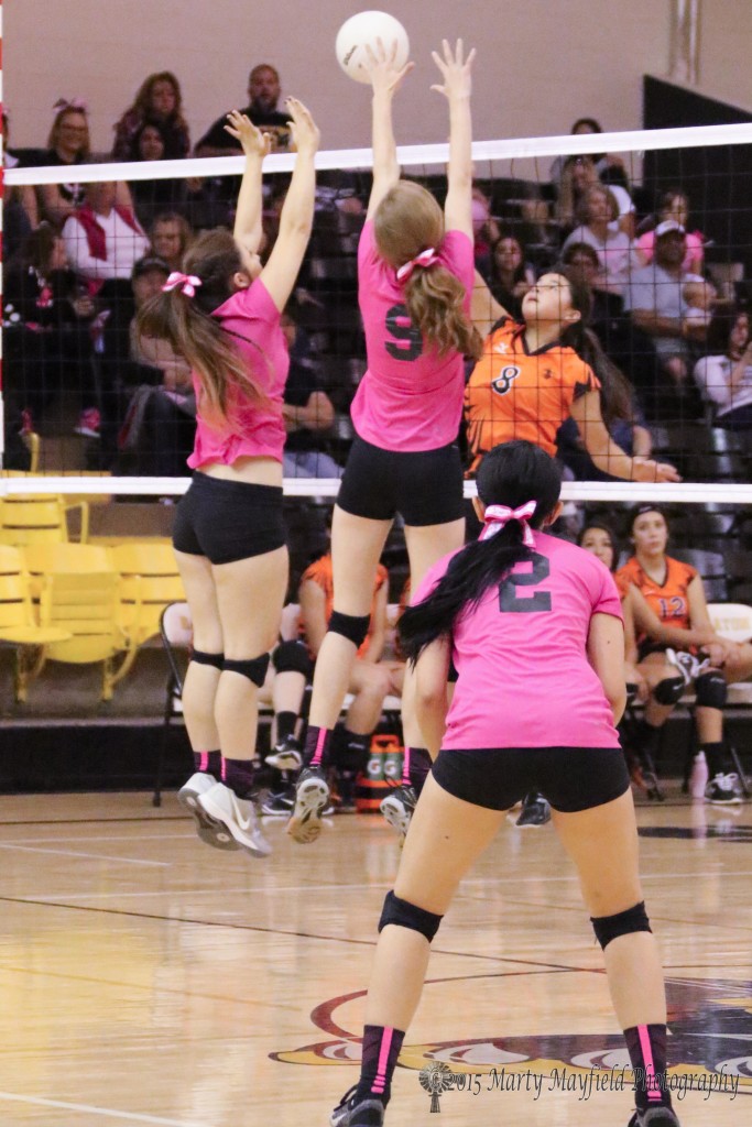 Camryn Stroeker and Alina Pillmore go up for the block as Jaelyn Sanchez makes the hit over the net Saturday in Tiger Gym.
