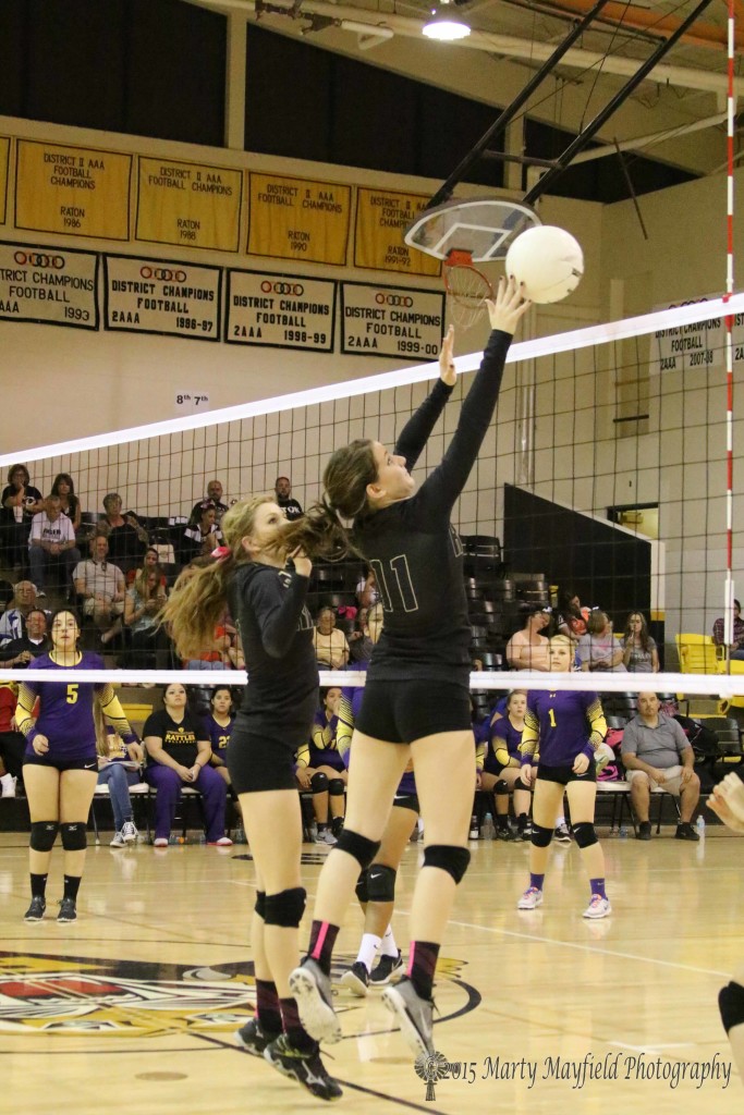 Camryn Mileta tips the ball on the block for Raton