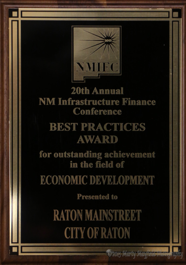 City Manager Scott Berry showed off the Award received by the city and Raton MainStreet 