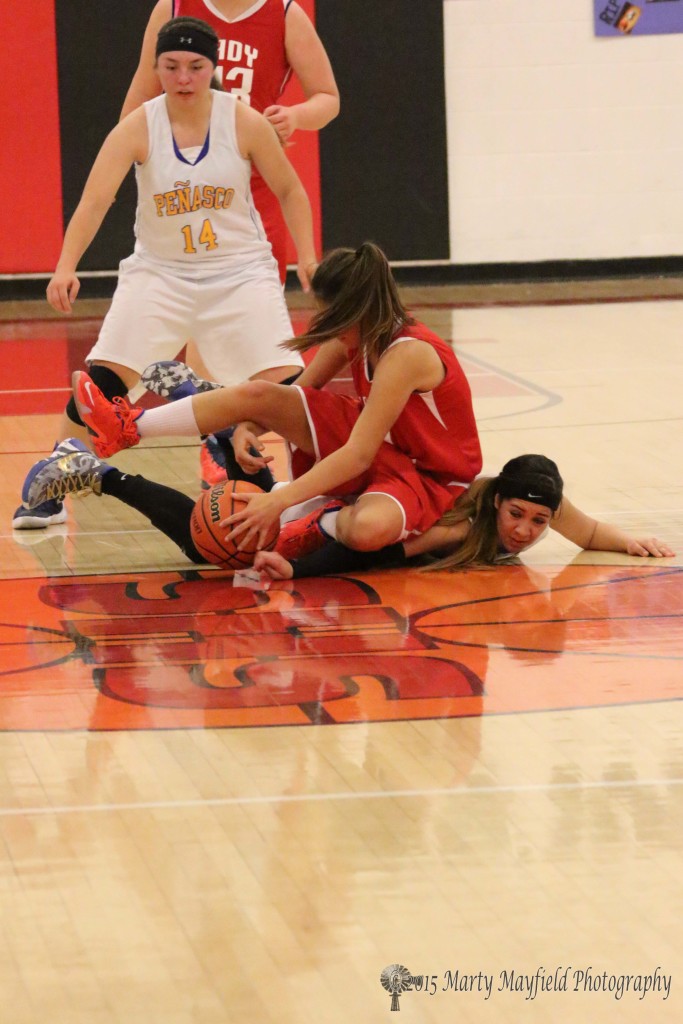 Its a scramble for the loose ball Lady Ram Angel Gonzales rolls over Lady Panther Bianca Contreras Tuesday night during the 2015 Cowbell Tourney
