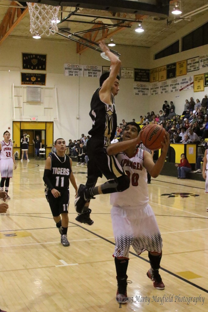 Grabbing air Jesse Espinoza goes for the block as Chris Casias works for the shot Friday night in Raton at the 2015 Cowbell tourney