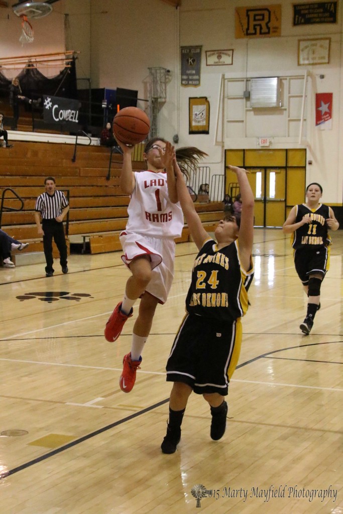 Angel Gonzales(1) goes for the lay-up as Amber Gonzales (24) runs in for the block Saturday morning at the 2015 Cowbell in Raton 