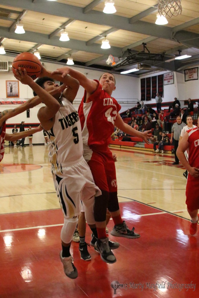 It was a physical game Tuesday as Raton and Cimarron battled it out, Jacob Garcia (just put of the pic) and Dominic Ickes (42) gets hand on Austin Jones as he attempts a shot at the 2015 Cowbell Tourney