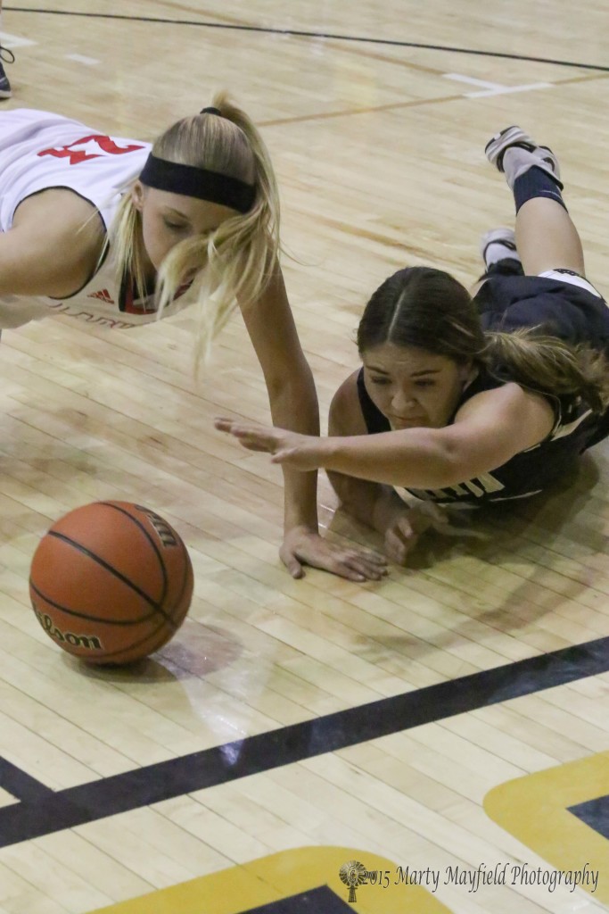 Lady Tiger Andie Ortega reaches for the ball as Danielle Blake also goes for the ball