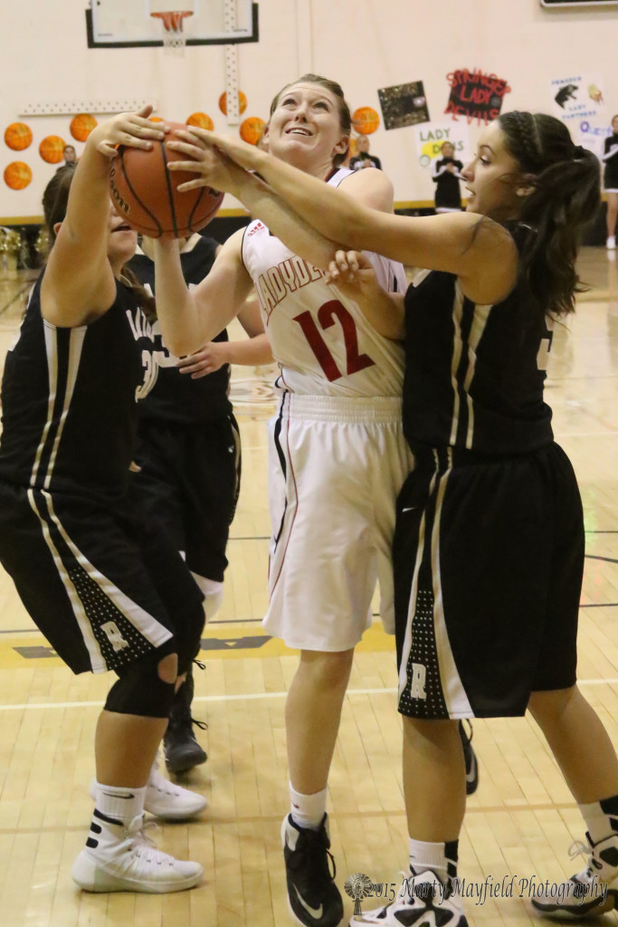 Andie Ortega and Sophia Maddaleni get an hand on the ball as Kara burton (12) goes for the shot during the girls championship game Monday evening.