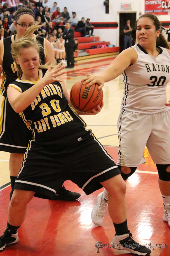 Annalisa Miller leans back to get her balance as Sydni Silva gets a hand on the ball Wednesday night during the 2015 Cowbell Tourney