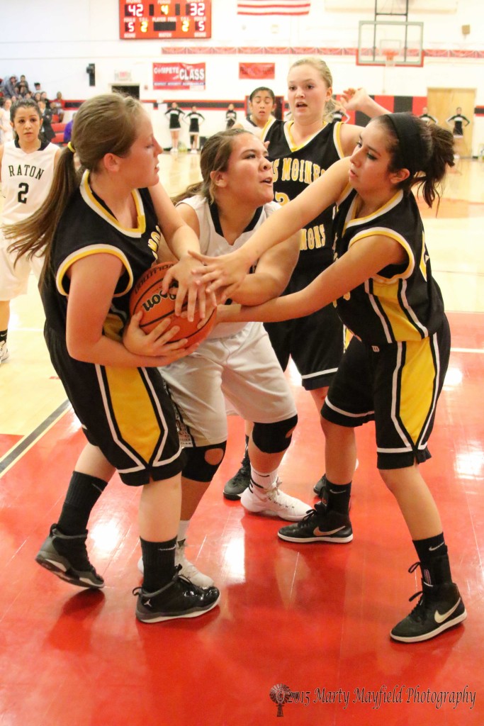 Rayelle Rivale, Alexis Wingo team up on Sydni Silva as they struggle to gain control of the ball during the 2015 Cowbell Tourney in Springer Wednesday night.