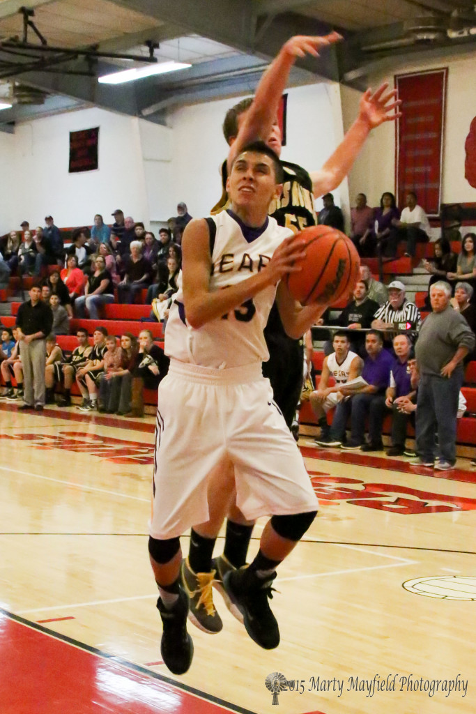 Aaron Salazar takes it in but his progress is impeded by a pesky Demon during the 2015 Cowbell Tourney in Springer Wednesday night