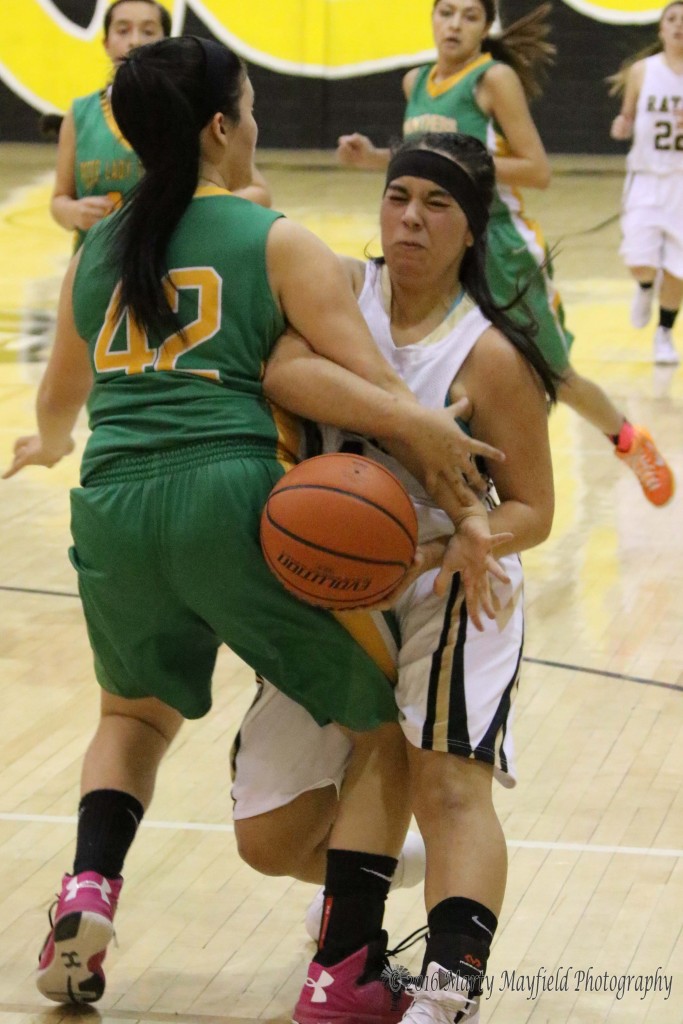 Breanna Muniz and Sarah P (42) tango for the ball during the JV game Friday evening in Tiger Gym