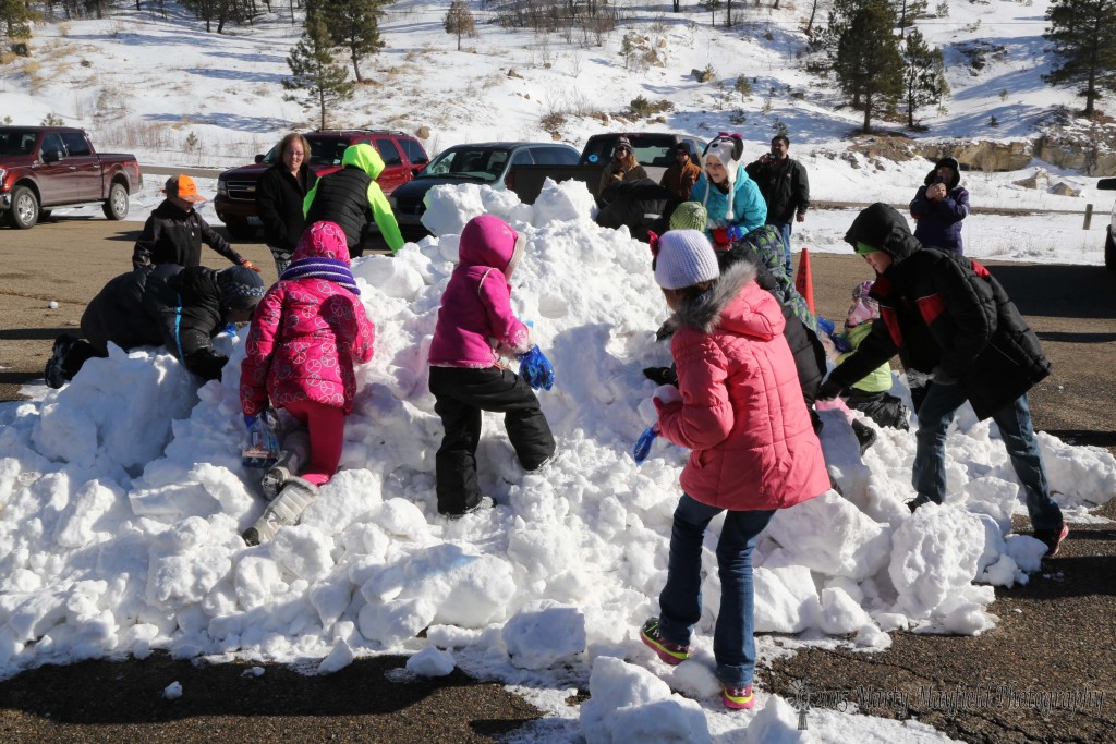 Kids under 12 even got in on the fun as they piled onto a pile of snow and dug for candy and money stored in plastic bags by the state parks rangers