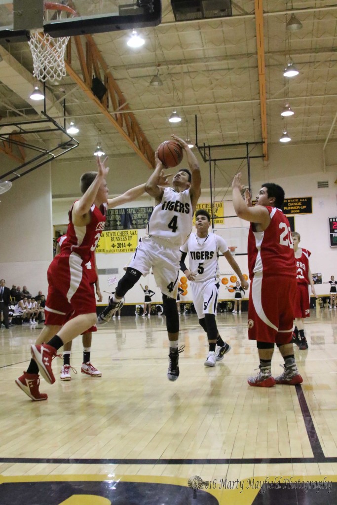 Matt Dean (32) gets a hand on Jonathan Cabrieles as he goes up for the shot Friday evening in Tiger Gym
