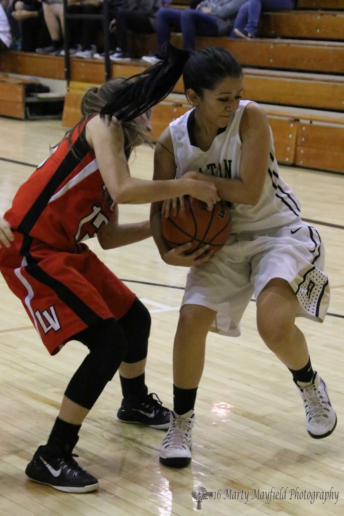 Natasha Ortega and Billie Jo Rinker struggle for the ball during the girls varsity game Thursday evening in Tiger Gym