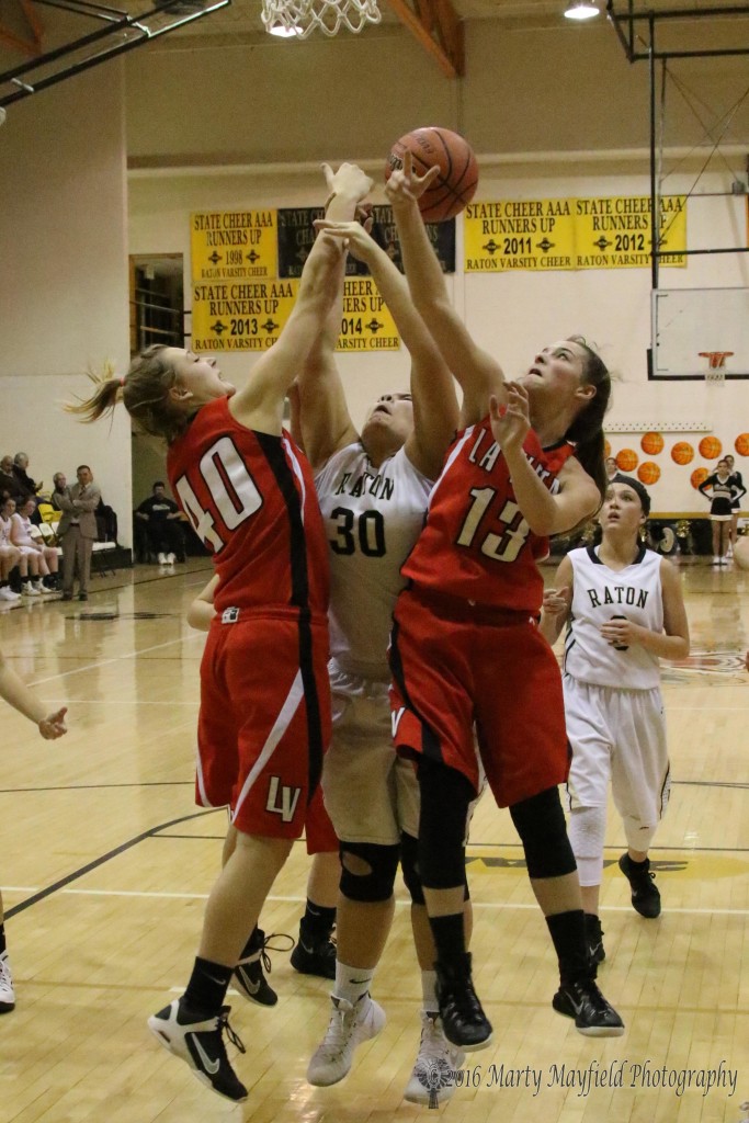 Shaylee Andreatta (40) and Billie Jo Rinker (13) get the squeeze play on Sydni Silva (30) as she goes for the shot 